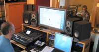 Ricardo playing violin in a studio, taping equipment in the front