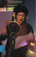 Lene, singing in a studio, in front of a microphone